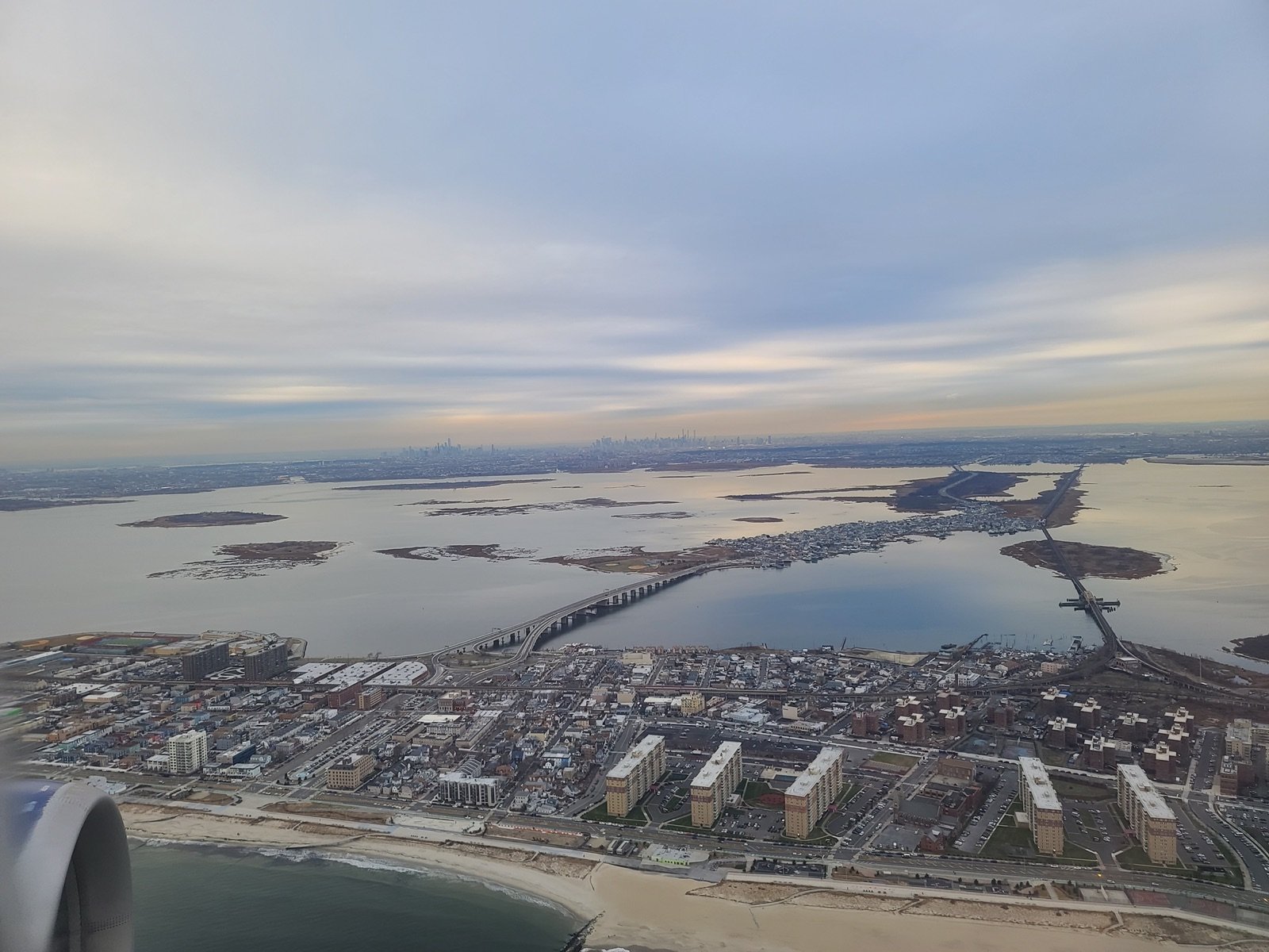 Aerial view of a coastal city and lagoon on approach to land