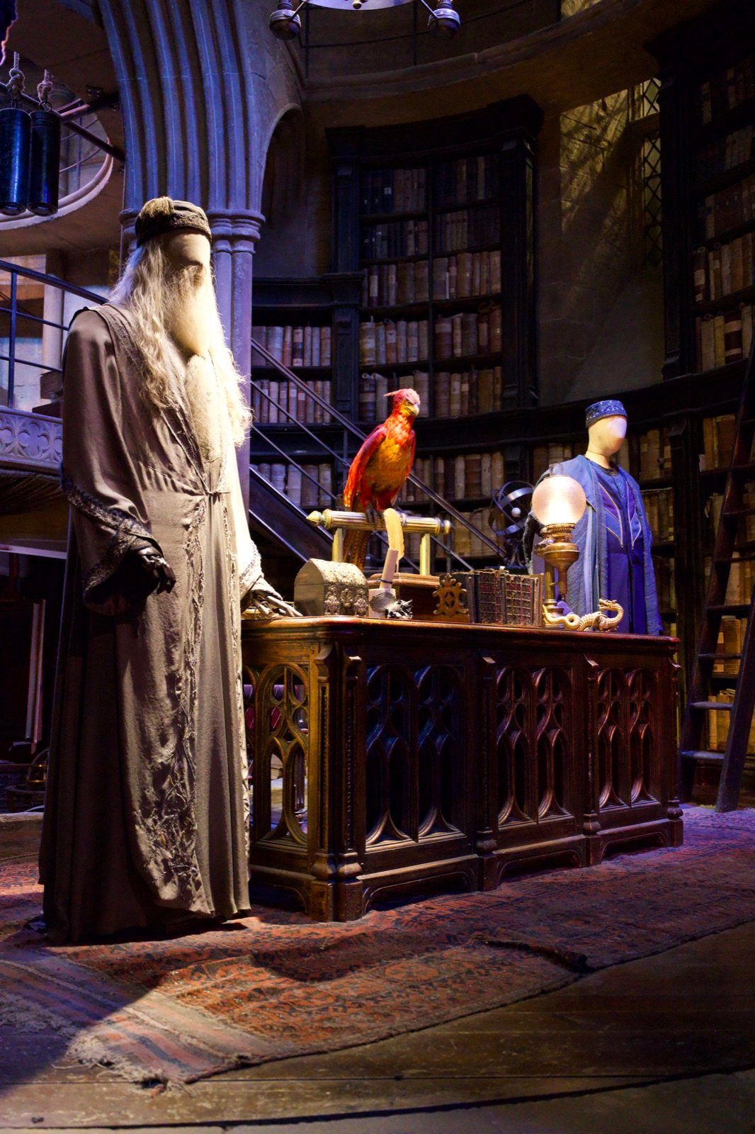 Film studio set with a wizard figure, phoenix, and library