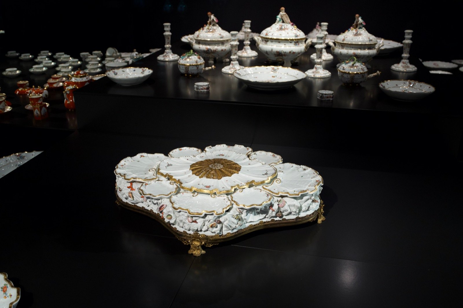 Ornate antique porcelain dinner service on display