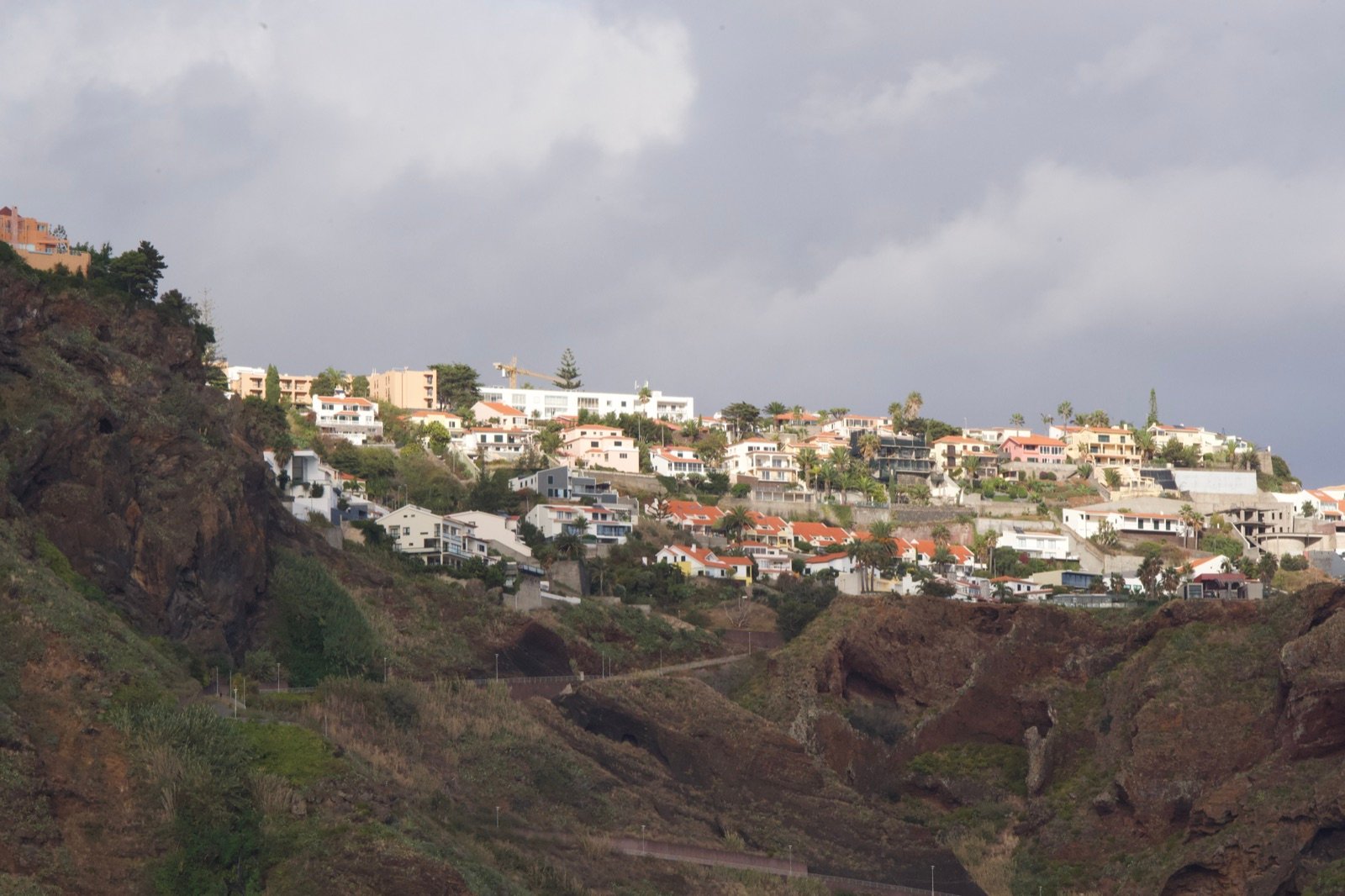 Madeira hillside town under moody clouds
