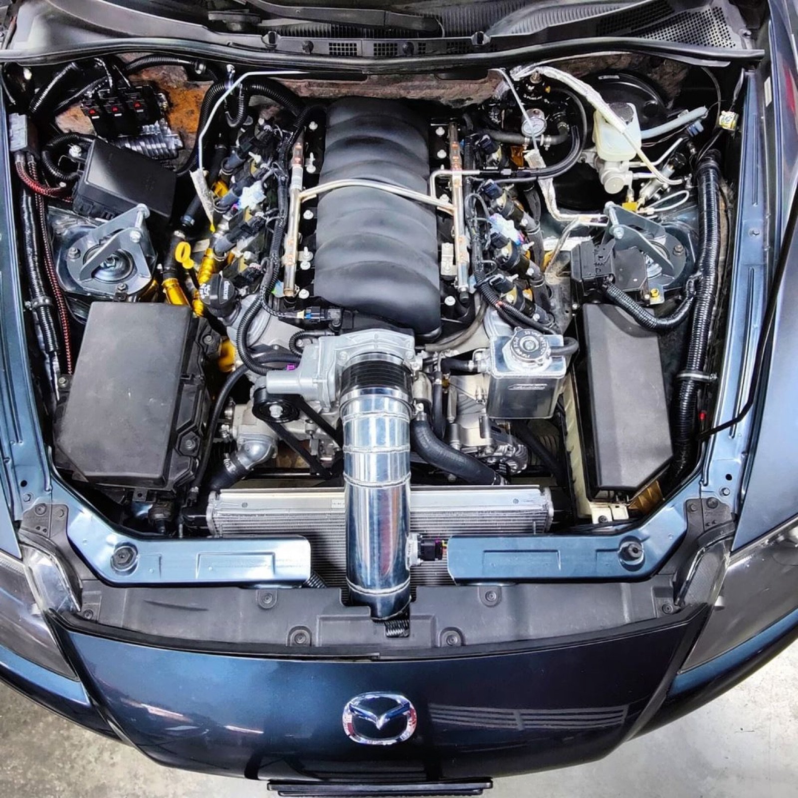 V8 engine bay swapped into a Mazda RX8